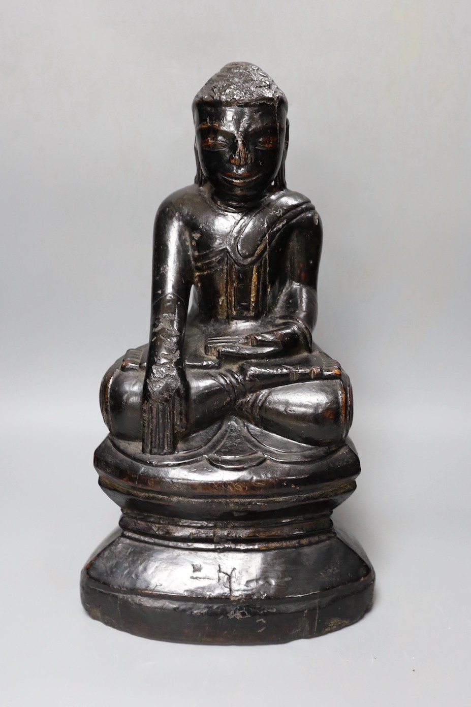 An 18th/19th century Burmese lacquered wood seated figure of Buddha Shakyamuni, 40cm